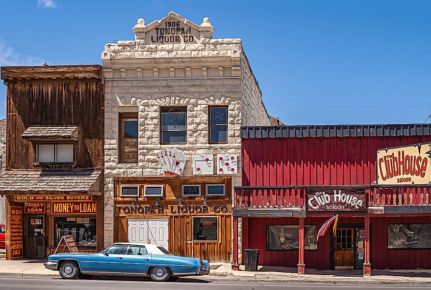 Three historic buildings in Tonopah holding iconic businesses against blue sky. Editorial credit: Claudine Van Massenhove / Shutterstock.com