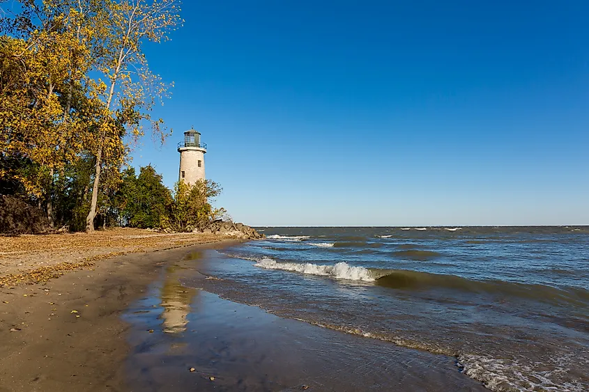 The historic Pelee Island Lighthouse, built in 1833, reflecting on its Lake Erie shoreline.