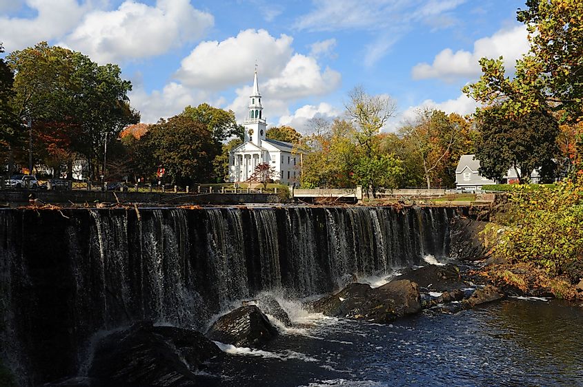 A waterfall with church in the background in the center of Milford, Connecticut