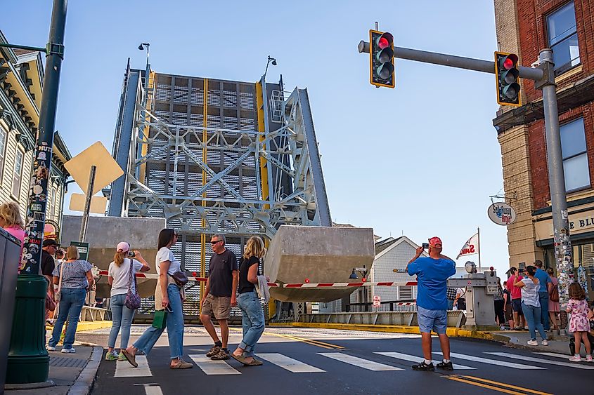 Tourists watch the rising of the Mystic River Bascule Bridge to allow sailboats and yachts pass under.