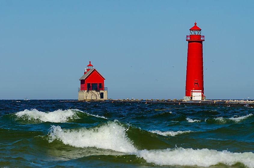 Waves on Lake Michigan roll past the Grand Haven Lighthouse in Grand Haven, Michigan