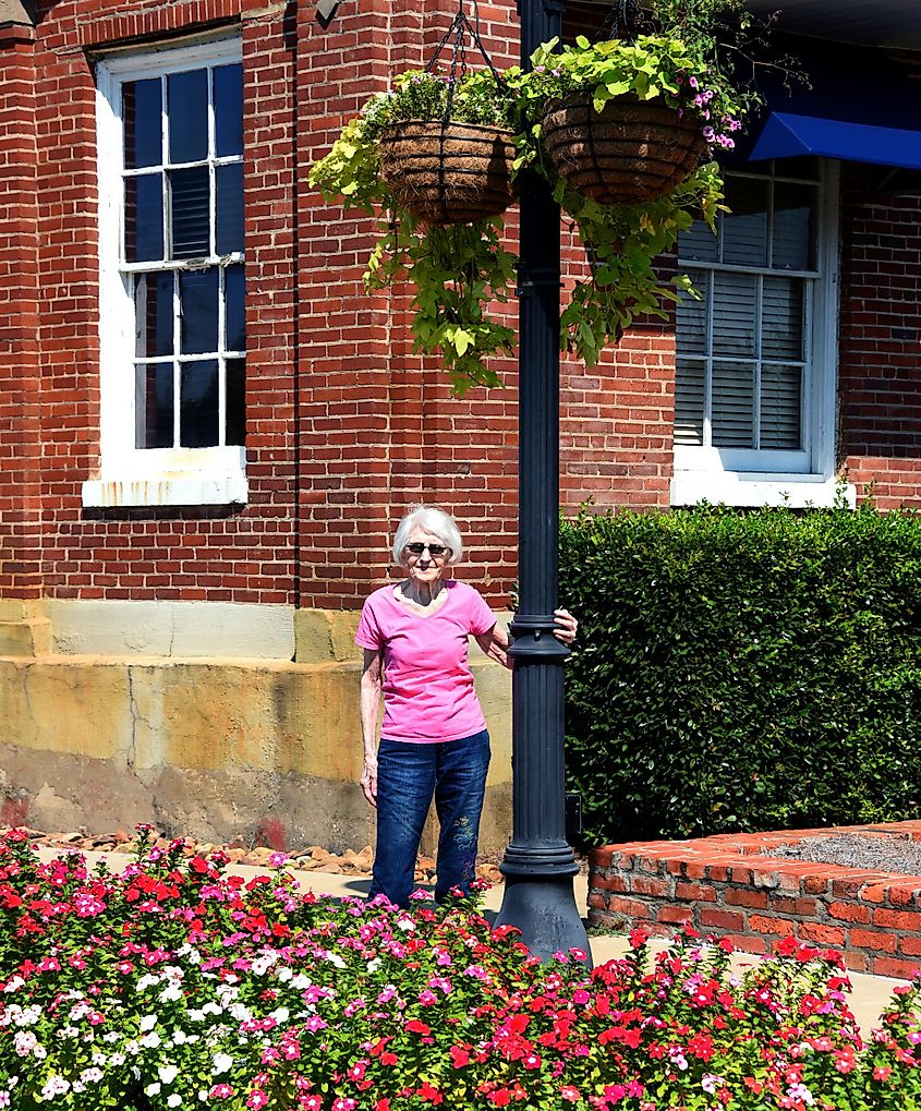 Woman, nearing 100 years old, explores Ruston, Louisiana. She is enjoying the sunshine and flowers.