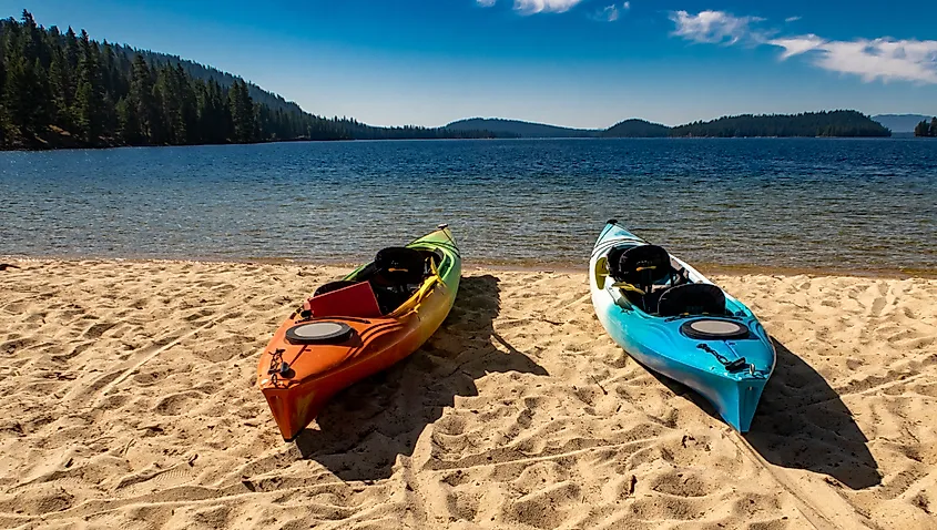 Two empty kayaks on the beach of Payette Lake near McCall, Idaho.