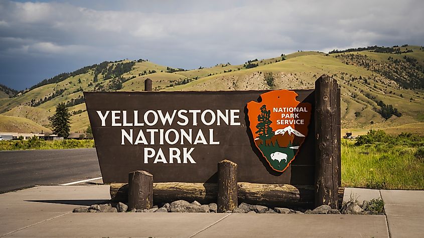 Gardiner, Montana USA - June 26th, 2024: Yellowstone National Park South Entrance Sign in front of the Roosevelt Arch at the north entrance to Yellowstone National Park. NayaDadara via Shutterstock