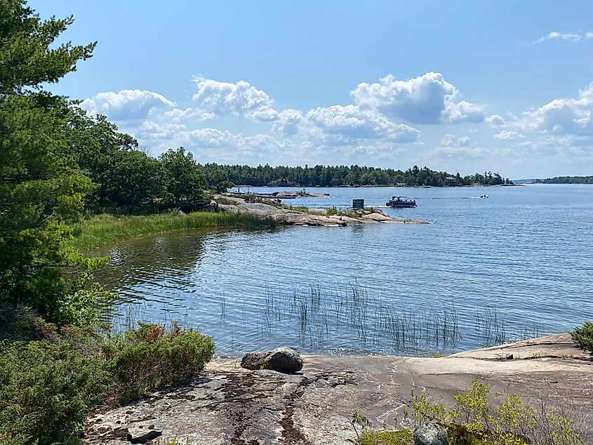 A small bay branches off from a forested granite island.