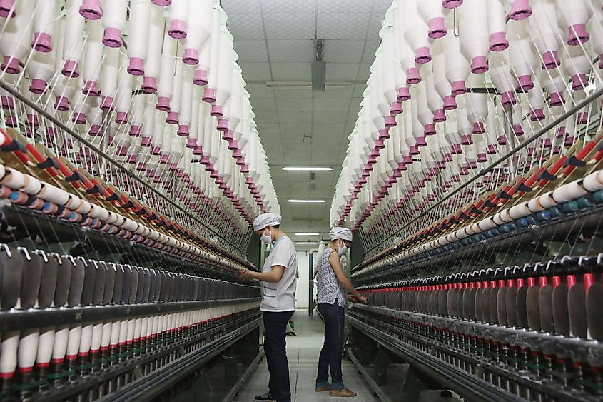 Workers are tight spinning in an industrial park spinning company production workshop in Jiujiang, China