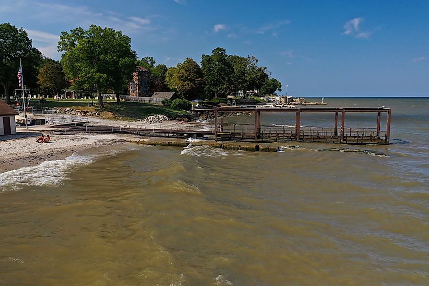 Avon Lake old boat dock, sandy beach and people taking in he rays