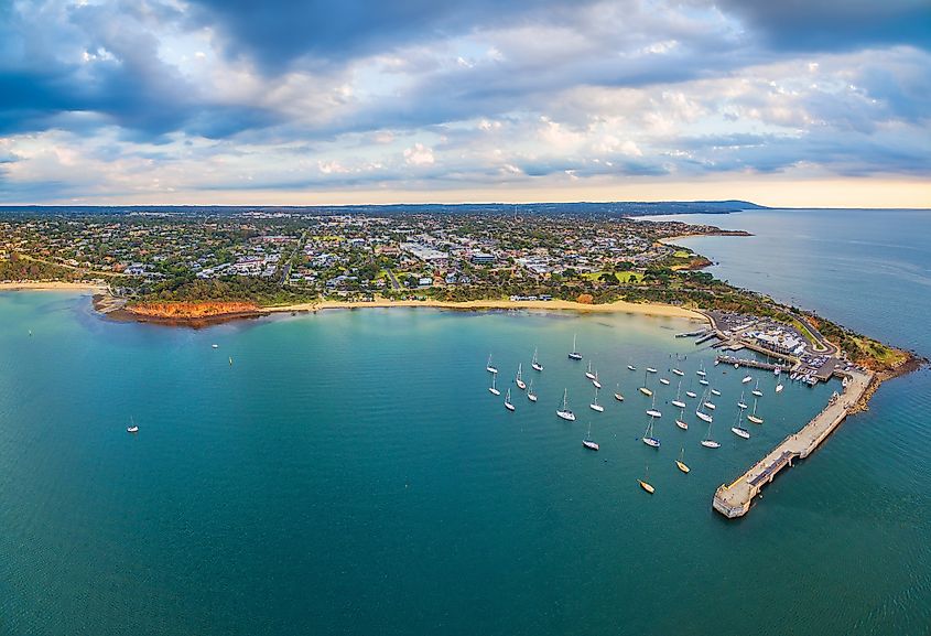 Beautiful aerial panorama of Mornington Peninsula coastline and Mornington Pier at sunset. Melbourne, Victoria, Australia.
