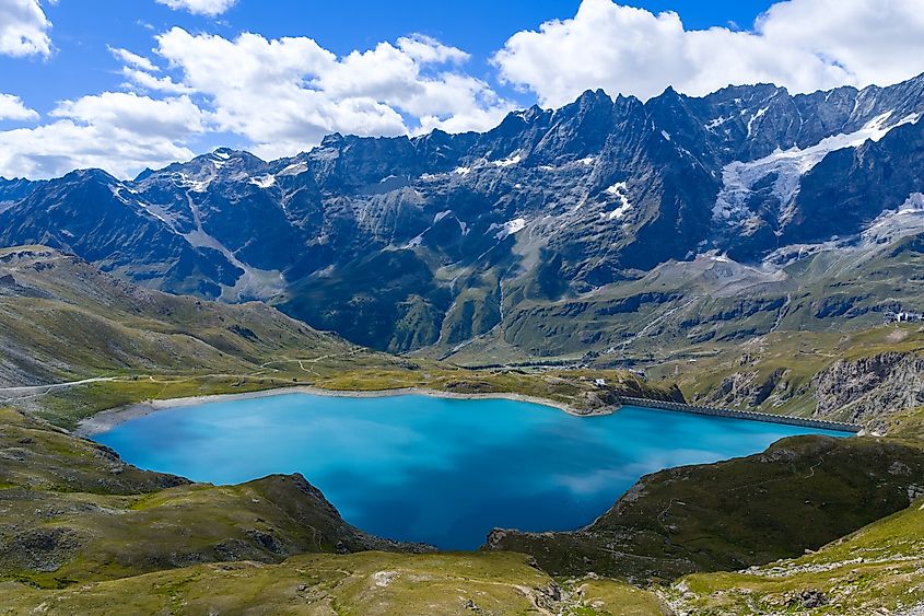 Turquoise waters of Lago Goillet reservoir beneath glaciated Alpine peaks near Valtournenche in the Aosta Valley, northwestern Italy.