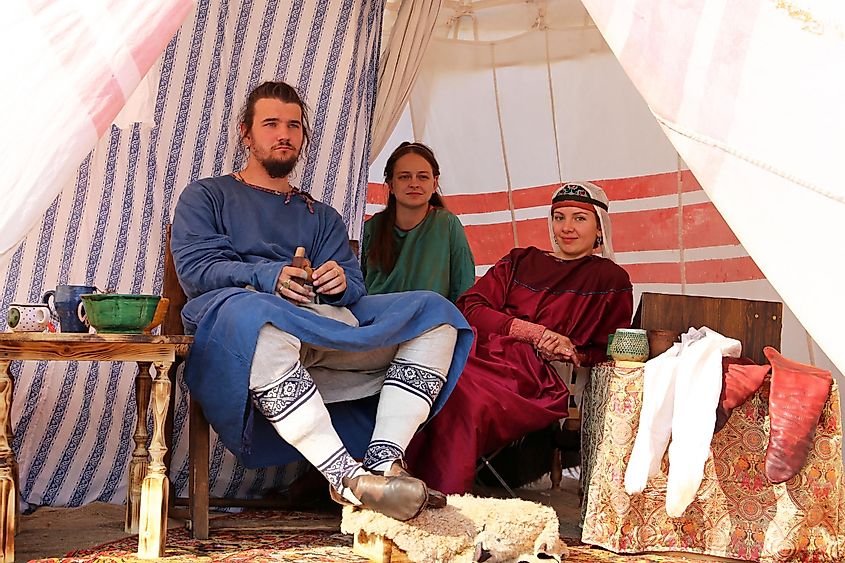 People in Byzantine clothes of 10th century in a patrician tent during the Moscow historical festival Times and epochs. Reconstruction of life in the Byzantine Empire