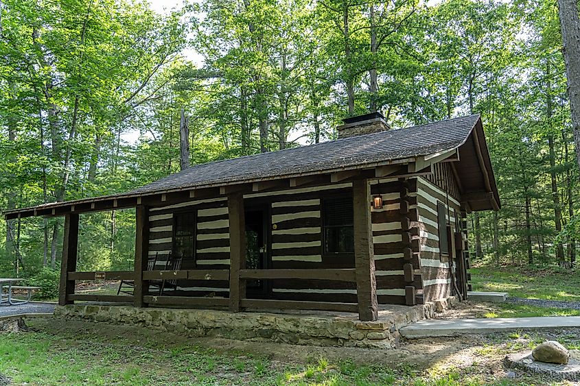 A Historic cabin built by the Civilian Conservation Corps in Douthat State Park. Via Shutterstock / Kyle J Little.