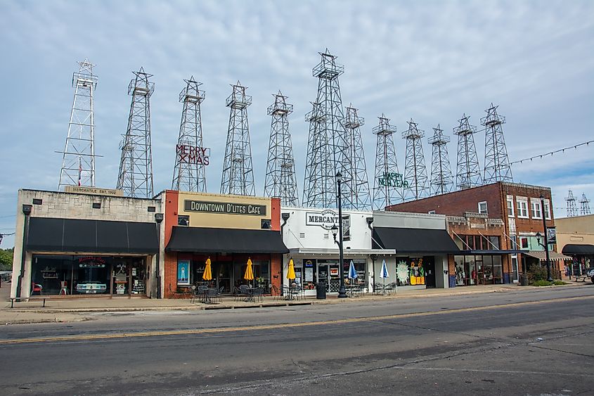 Iron oil derricks towering over the historic Main Street in Kilgore, Texas.