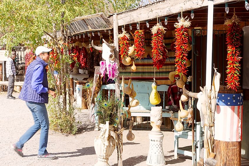 Tourist looking at the ristras hanging in front of the store in Mesilla, New Mexico, via Grossinger / Shutterstock.com