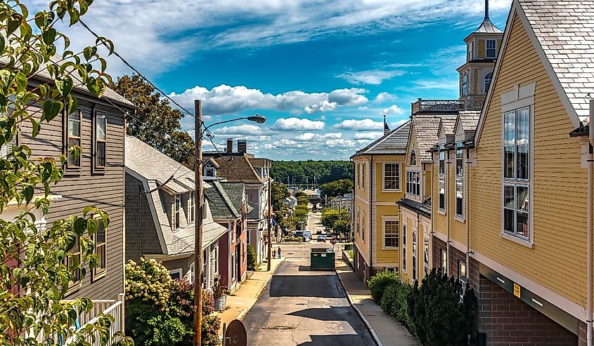 Town of East Greenwich with street scenes and yellow house on the right.