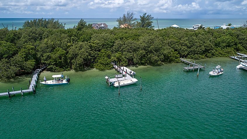 Aerial View from a Drone Featuring Boats Docked on the Bay with an Island and the Gulf of Mexico in the Background in North Captiva Island, Florida