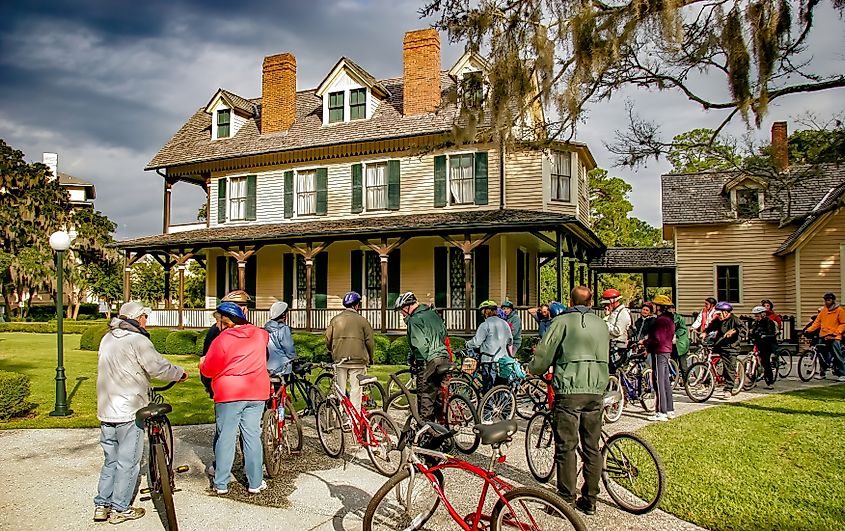 A bicycle tour group resting in front of one of the historic homes on St Simon island, Georgia. Editorial credit: Bob Pool / Shutterstock.com