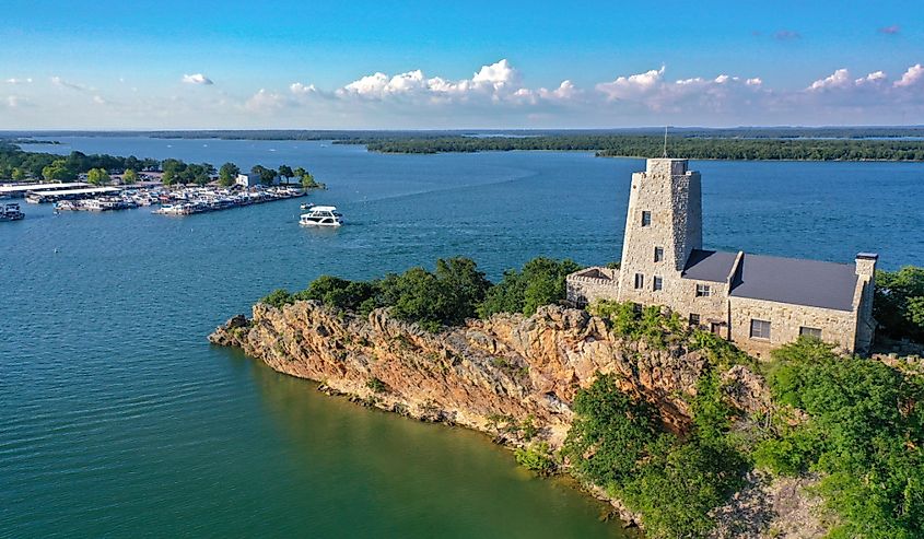 Aerial view of Tucker Tower on Lake Murray in Ardmore Oklahoma on a summer day with a houseboat in the distance