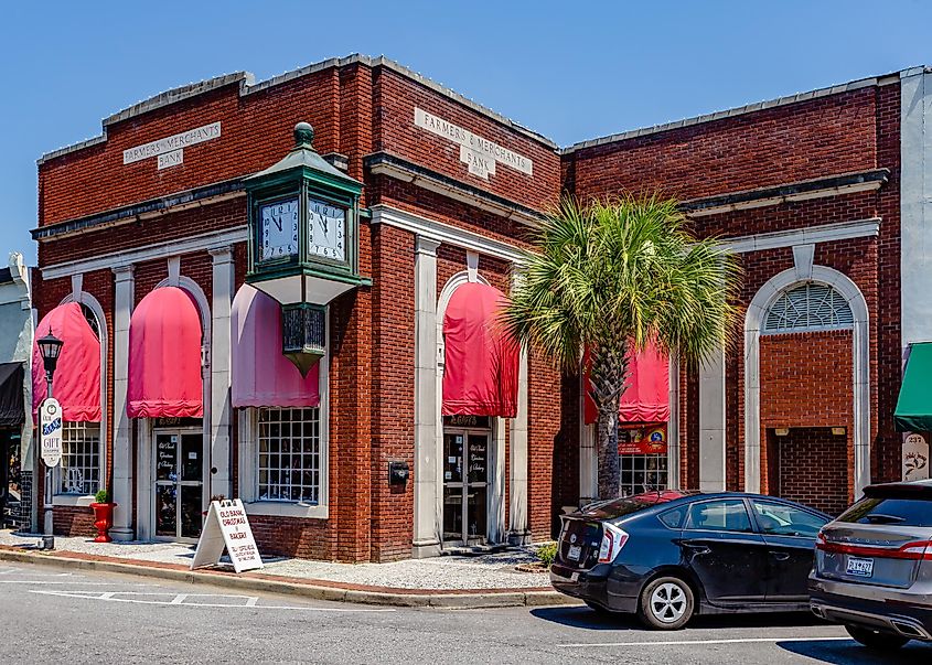 The First Merchants Bank building, circa 1902, featuring a copper and glass clock located in downtown Walterboro, SC. Editorial credit: George Howard Jr / Shutterstock.com