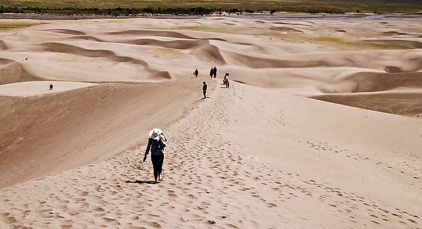 Hikers traverse a portion of Great Sand Dunes National Park and Preserve.