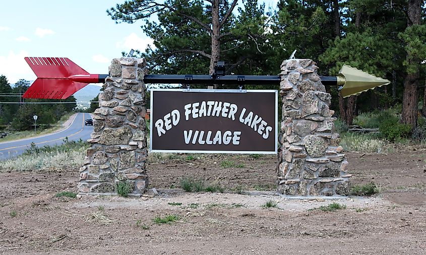 A sign pointing to Red Feather Lakes Village.