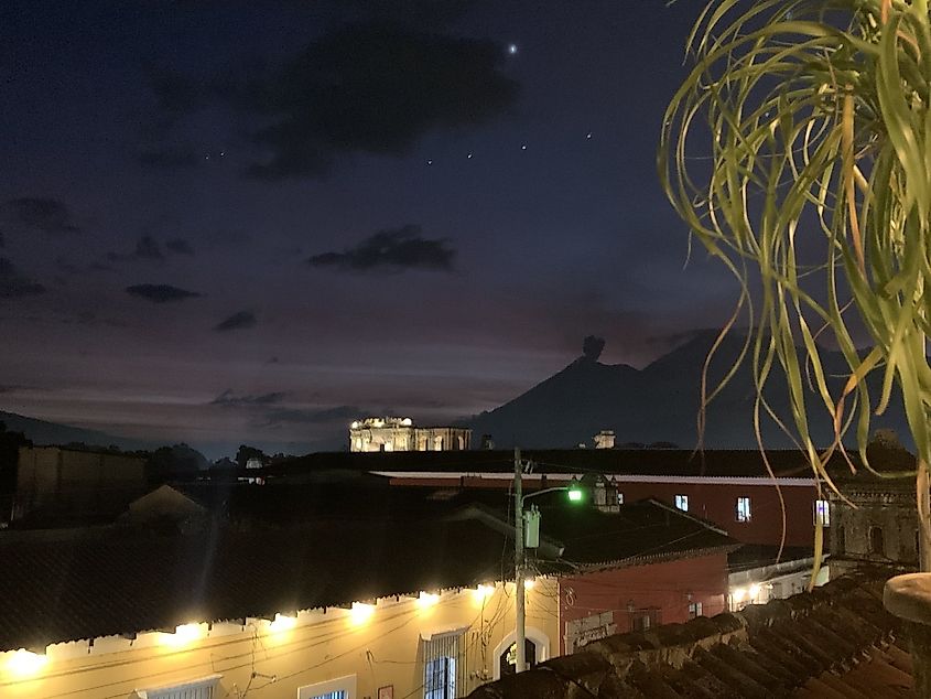 A evening skyline seen from an illuminated craft brewery balcony