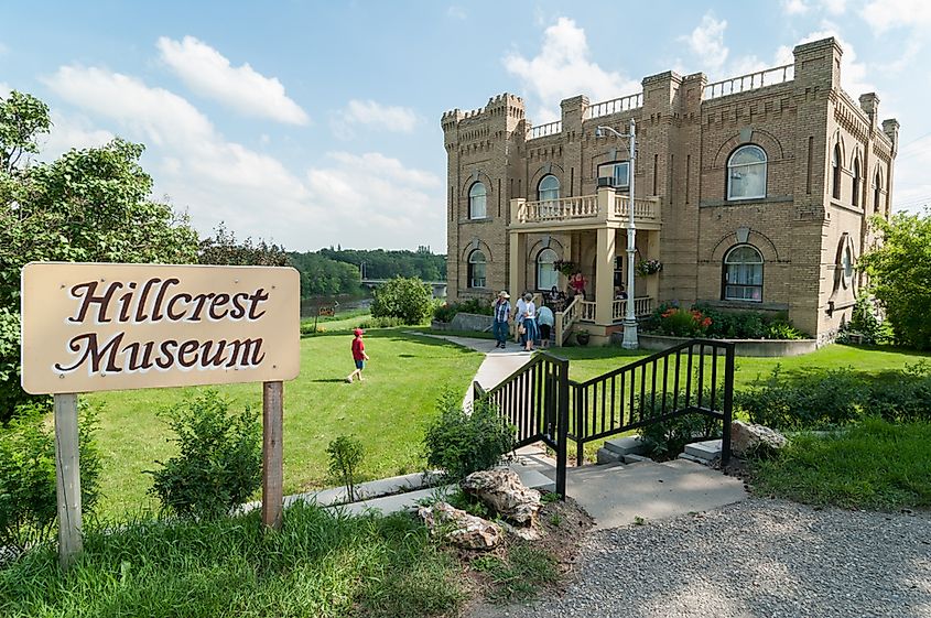 Visitors in front of the main building of the Hillcrest Museum on a late summer afternoon.