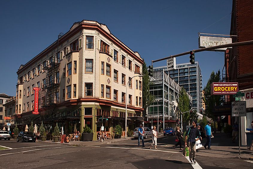 Horizontal shot of a bustling street corner in Pearl District, with historic buildings and a cafe, Portland, Oregon