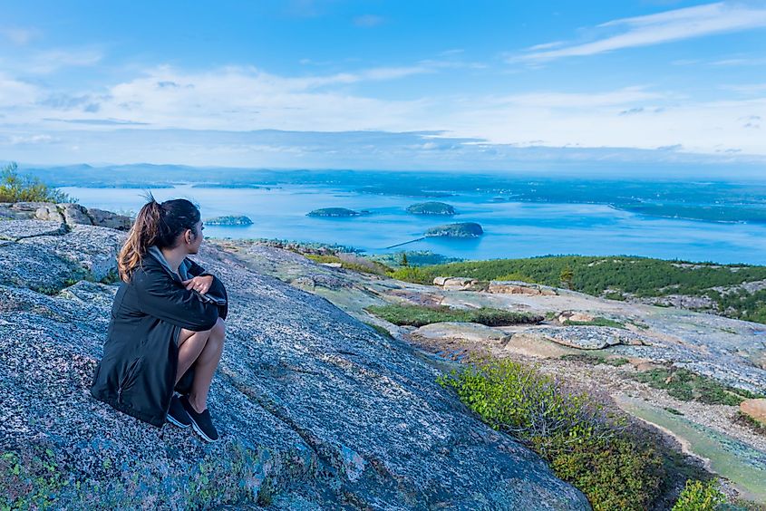 A woman enjoying the beautiful view from Cadillac Mountain