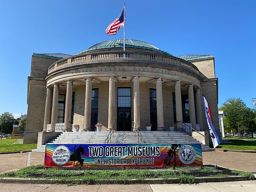 A round historic post office building now home to "Two Great Museums," as branded by the rainbow banner out front. 