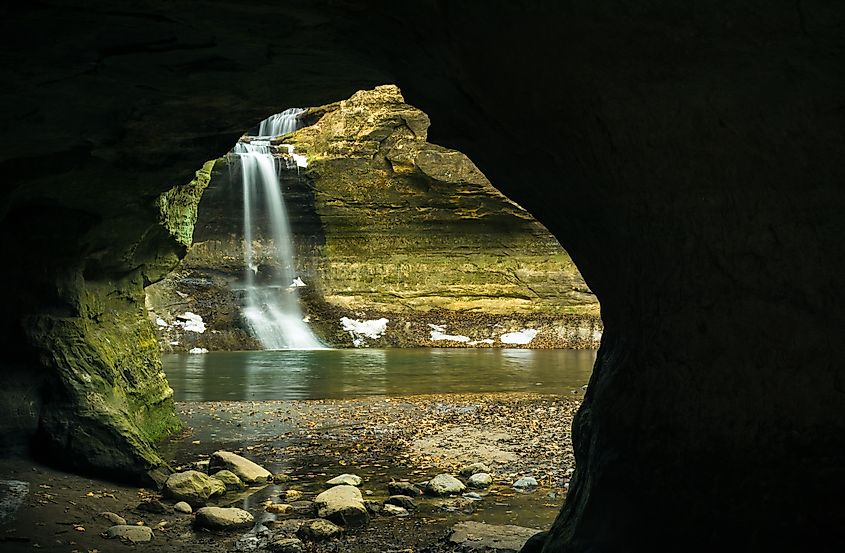 View through the cave to a Winter cascade in the Lower Dells. Matthiessen State Park, Illinois