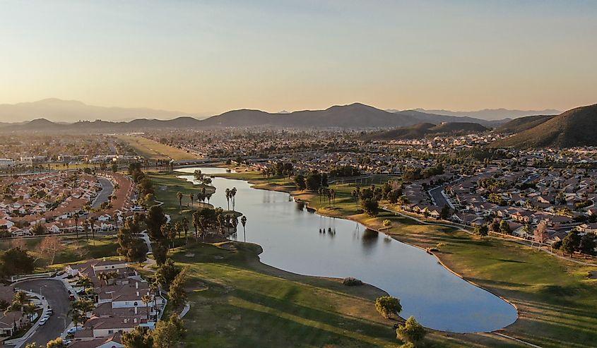 Aerial view of golf course surrounded by town houses and luxury villas during sunset time, Temecula, California