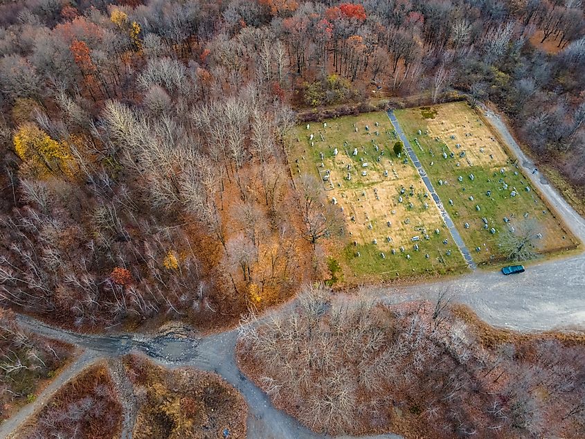 Aerial top-down of cemetery and forest in the Fall around the abandoned coal town, Centralia, Pennsylvania.