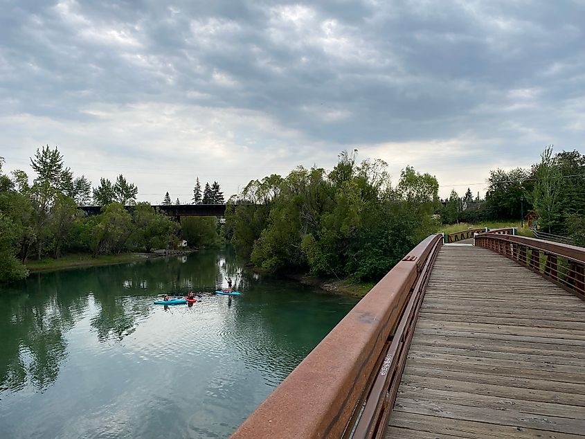 River paddlers as seen from atop a boardwalk bridge.