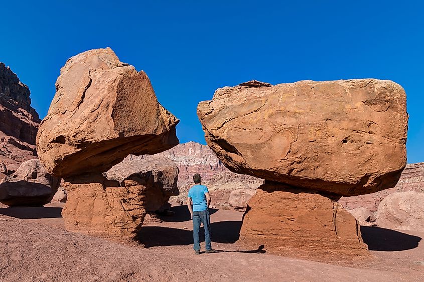 Man looking up at Balanced Rock, Marble Canyon, Arizona, USA