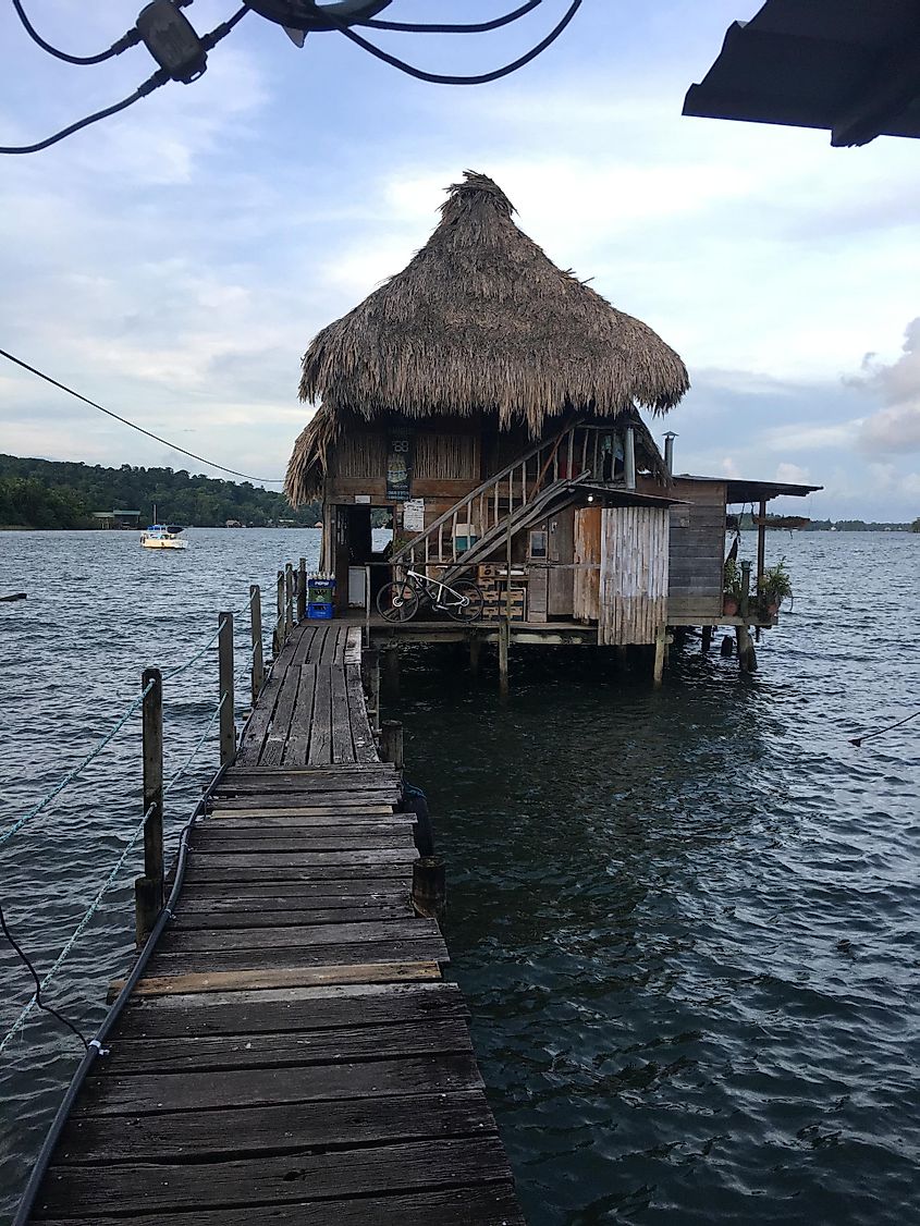 A wooden hut sitting on a waterside dock.
