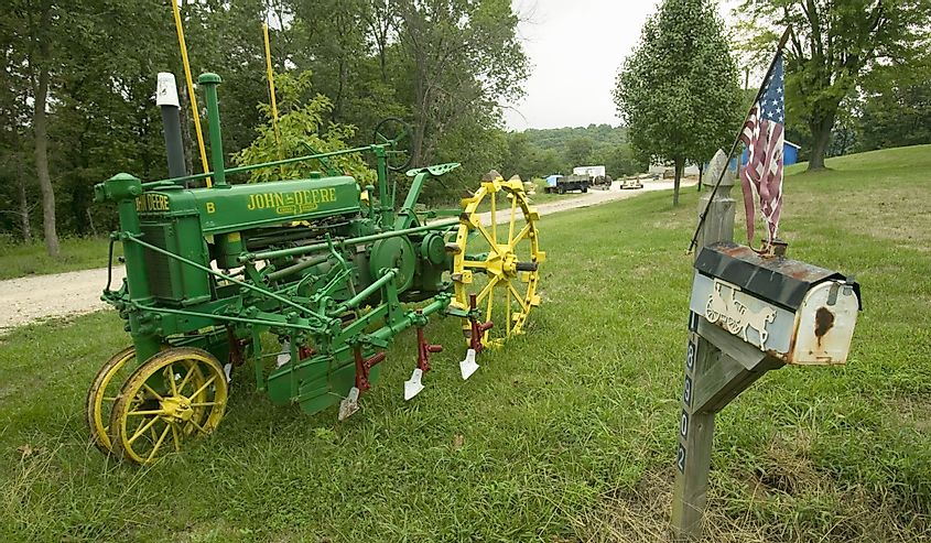 Antique John Deere tractor in front of yard along Manchester Road, Missouri