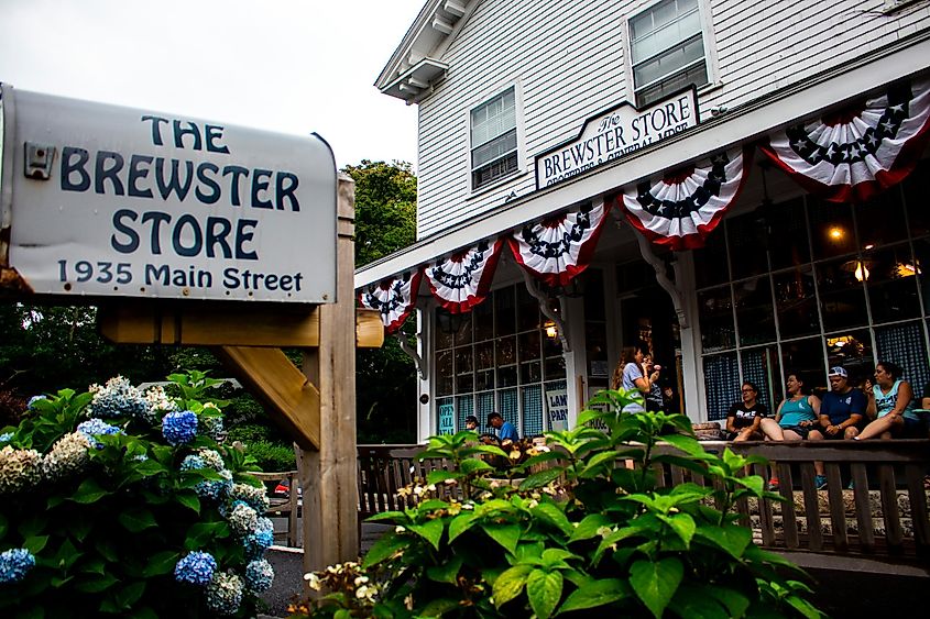 The iconic Brewster Store with the metal mail box in the foreground and the storefront with patrons enjoying ice cream on the deck in the background