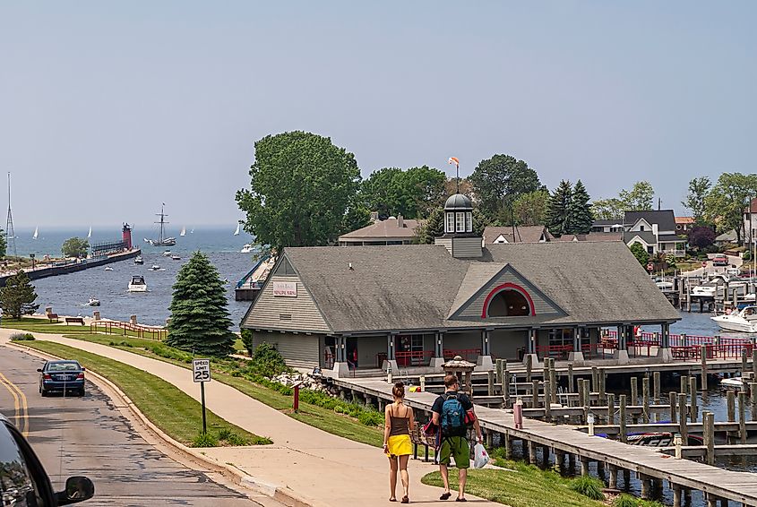 South Haven, MI: Municipal Marina building built on Black River emptying in Lake Michigan under blue sky