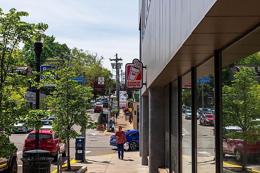 The Dunkin Donut sign on the business along Shady Avenue in the Squirrel Hill neighborhood on a sunny spring day, via woodsnorthphoto / Shutterstock.com
