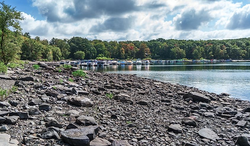 Rocky shore of Lake Wallenpaupack with boats in the harbor