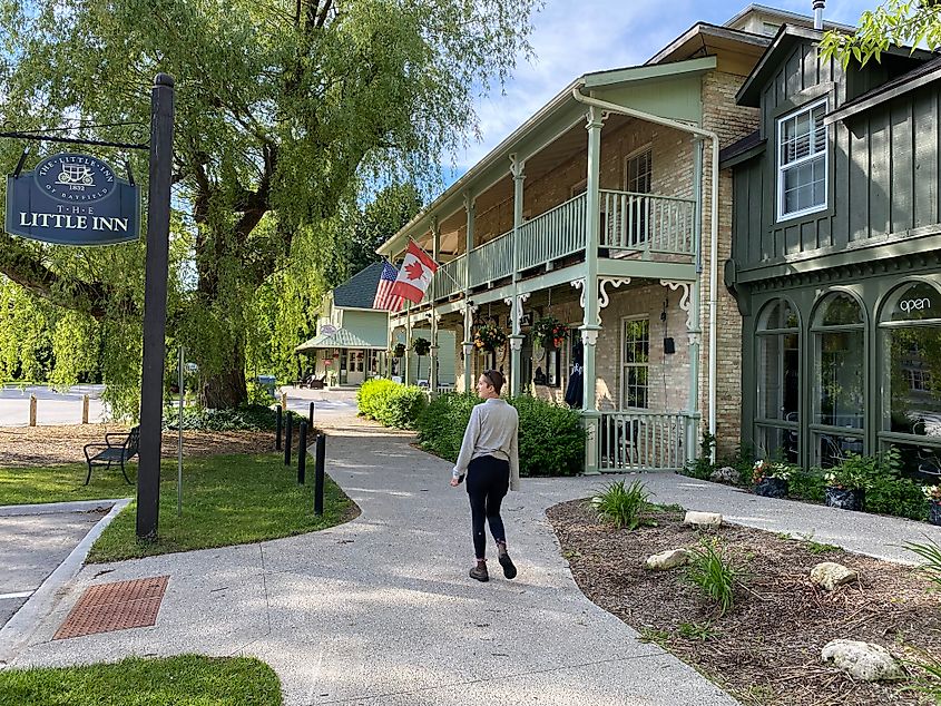 A young woman strolls the timeless Main Street of Bayfield, Ontario.