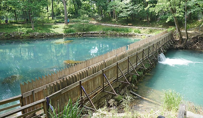 Beautiful blue water of a natural spring by a dam near Blue Spring Heritage Center, Eureka Springs, Arkansas
