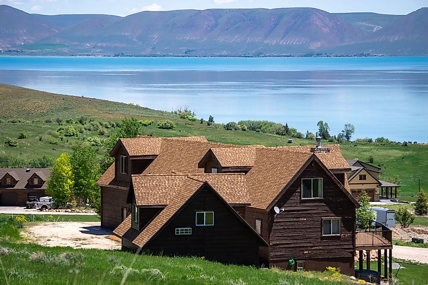 View of Bear Lake on the Idaho side with a cabin facing the lake on the hillside