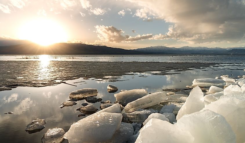Ice stacks at Vineyard Beach on Utah Lake at sunset.