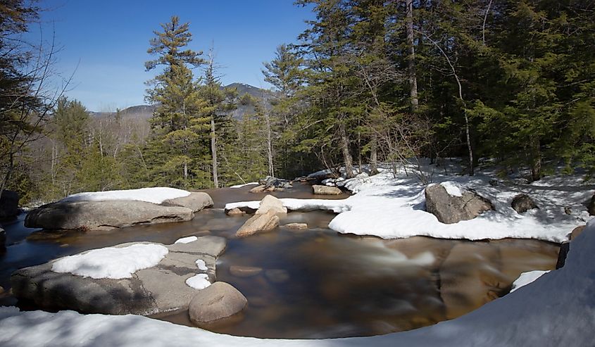 Waterfall at Diana's Baths in North Conway, New Hampshire in the spring with melting snow.