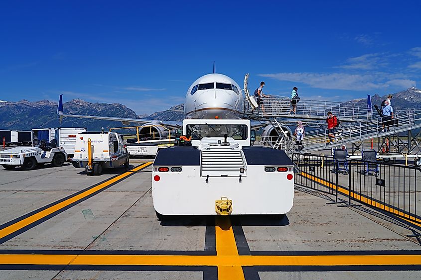 Passengers disembarking at the Jackson Hole Airport located inside the Wyoming Grand Teton National Park that has strict height and noise requirements. Editorial credit: EQRoy / Shutterstock.com