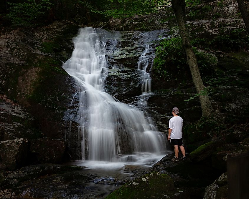 A visitor admiring the beauty of the Crabtree Falls in Virginia.