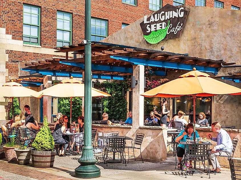 The Laughing Seed Cafe, on Wall St. in downtown Asheville, is busy with customers in the open air environment, via Nolichuckyjake / Shutterstock.com