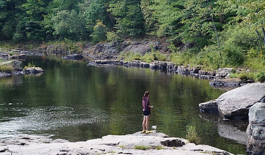 Young girl fishing at Tobyhanna Creek, Pennsylvania