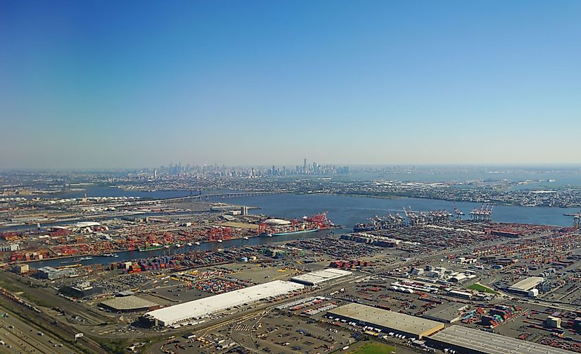 View of cranes and containers at the Port of Newark-Elizabeth, New Jersey, with Manhattan in the background.